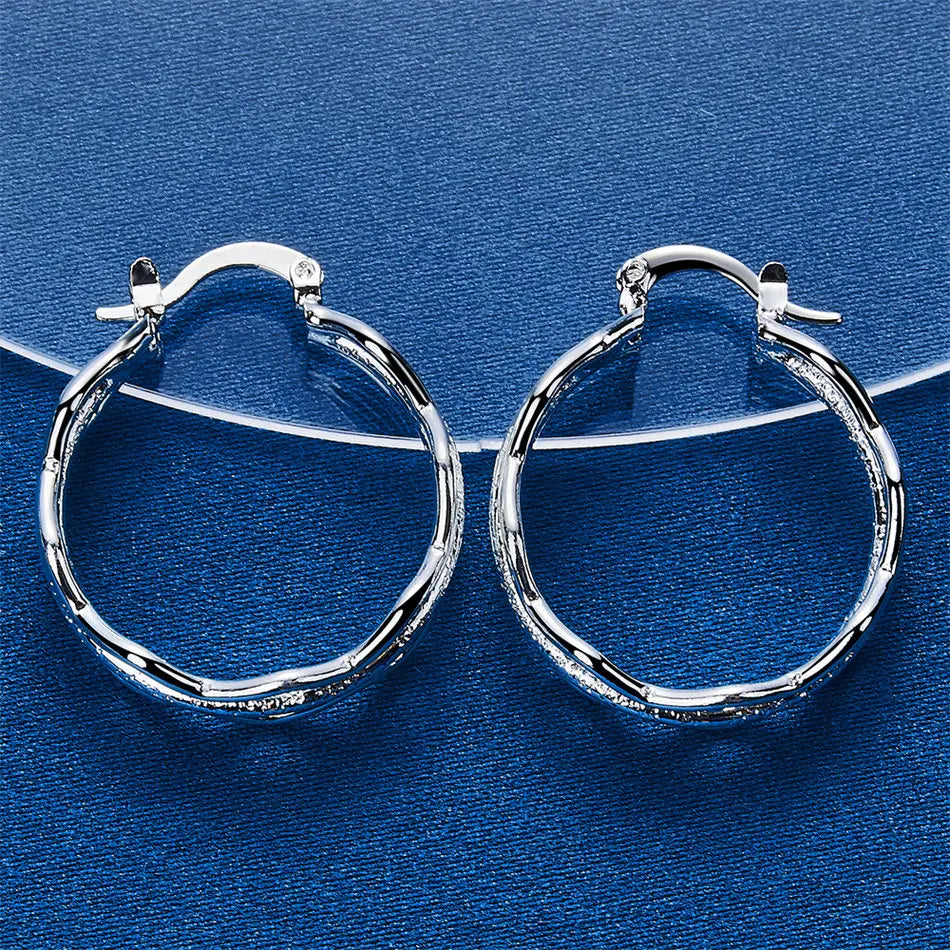 Silver 925 pendant earrings with wave design, crafted by Corporación Turística, featuring sleek and elegant silver jewelry.