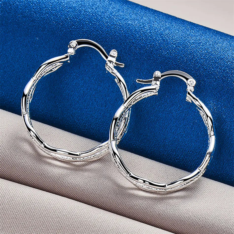 Sterling silver 925 wave design earrings featuring elegant, flowing patterns, ideal for stylish and contemporary jewelry.