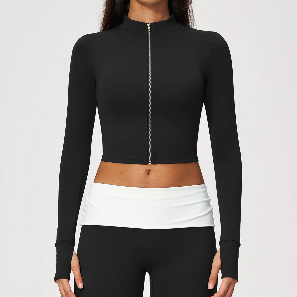 Pomegranate red women's long-sleeve sports t-shirt with zipper, from Corporación Turística, displayed flat on a white background.