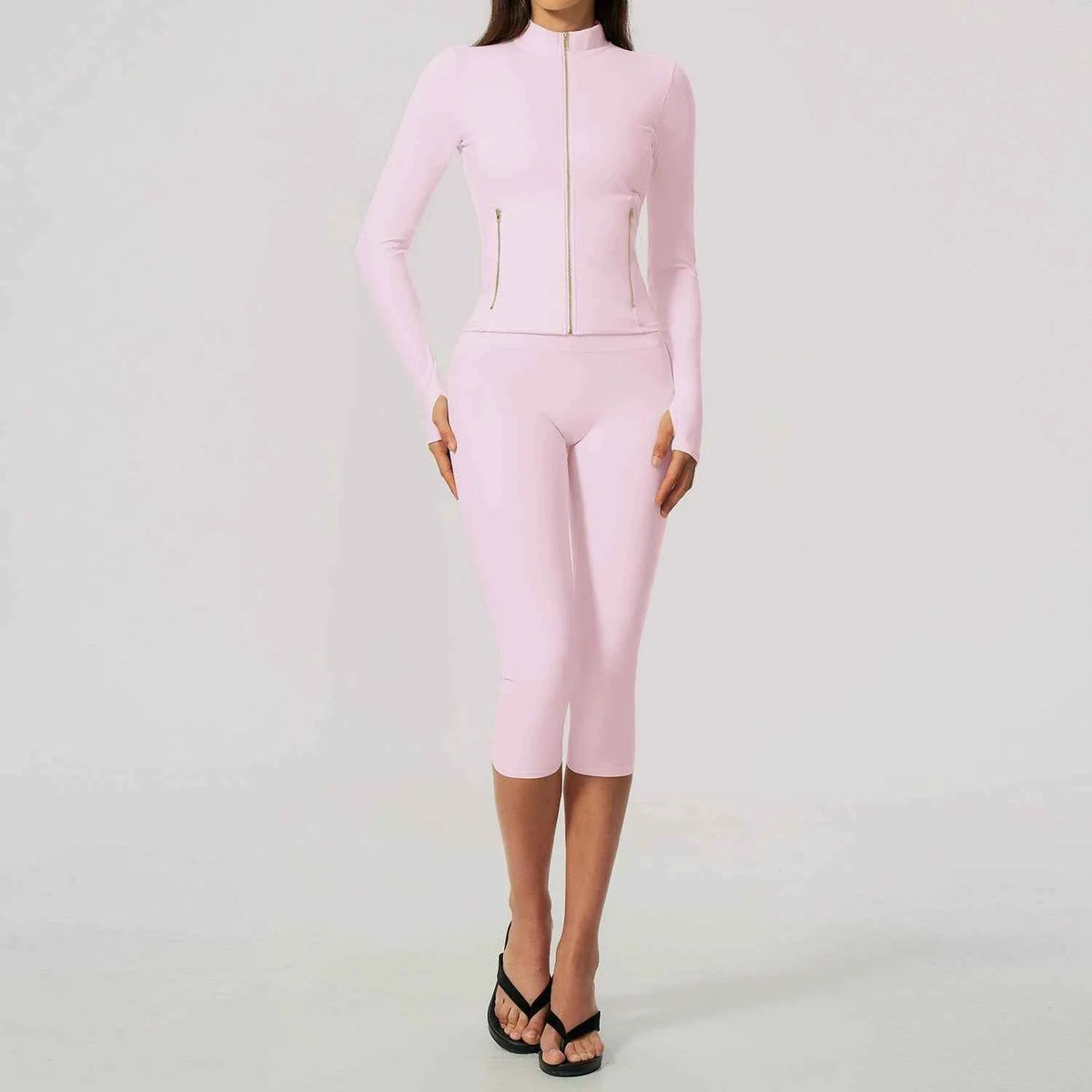 Black women's yoga sports set by Corporación Turística, including a long-sleeve top and matching athletic pants.