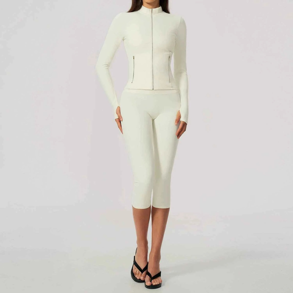 Black women's sportswear set by Corporación Turística, includes yoga top with long sleeves and matching leggings.