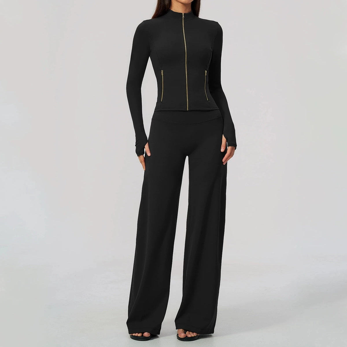 Black women's yoga sports set by Corporación Turística, featuring a long-sleeve top and matching workout leggings.