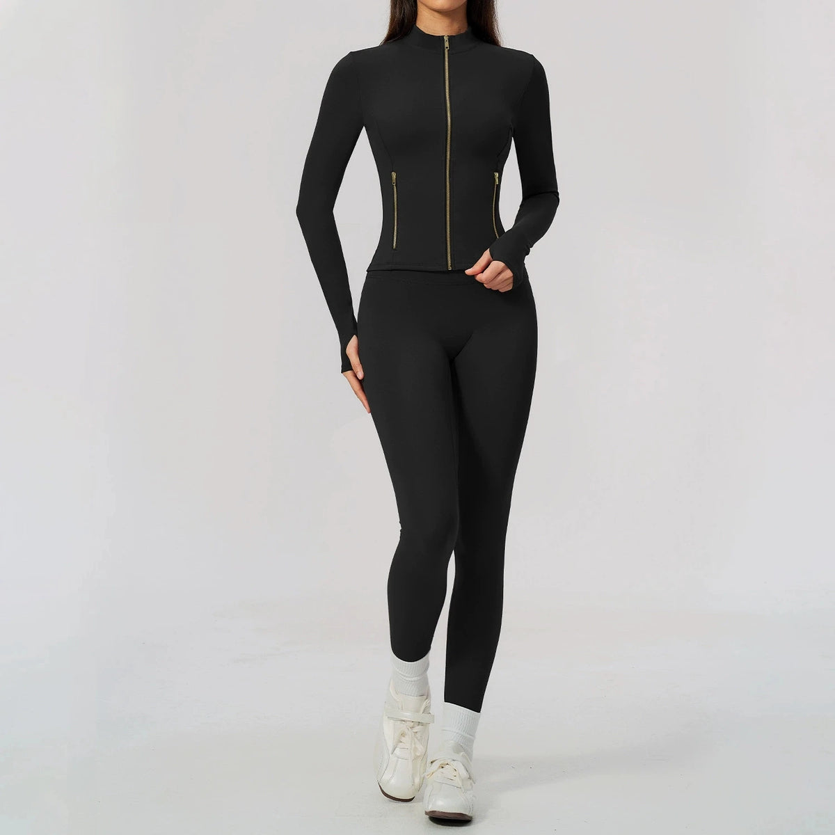 Black women's sports set by Corporación Turística, including a yoga top with long sleeves and matching athletic bottoms.