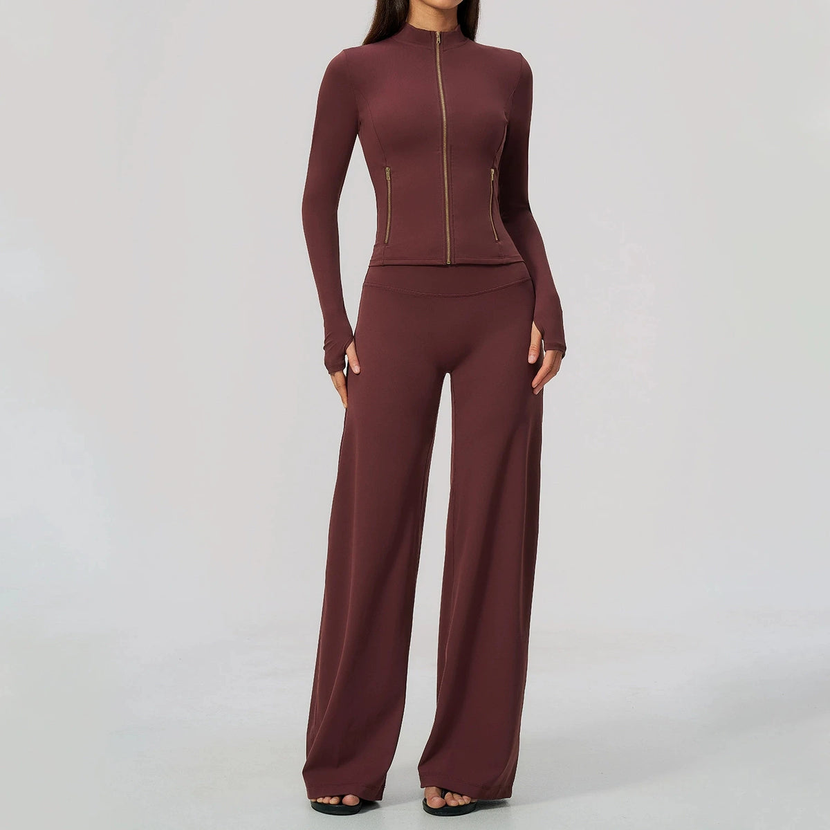 Black women's sports set from Corporación Turística, including yoga top with long sleeves, perfect for active wear and exercise.