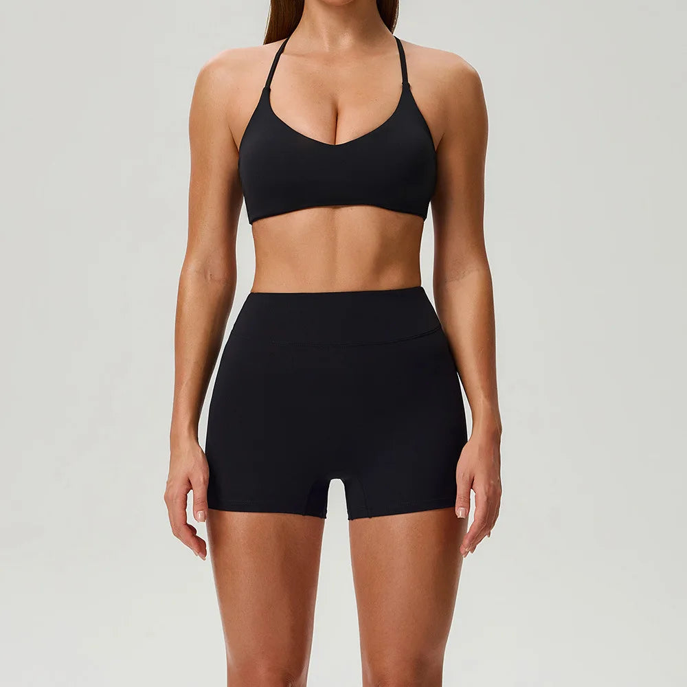 Black 2-piece women's sports set by Corporación Turística featuring a fitted top and matching leggings for activewear.