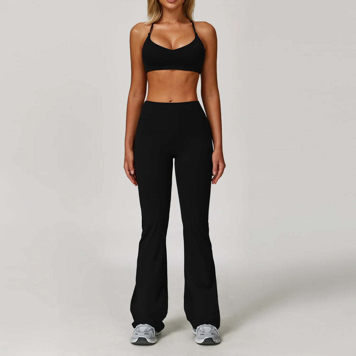 Black 2-piece women's yoga set by Corporación Turística, includes sports top and leggings, suitable for activewear and exercise.