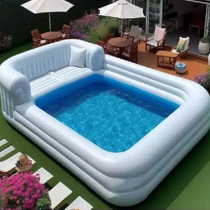Inflatable pool with floating bar, wrap-around sofa, and surrounding lounge area by Corporación Turística.