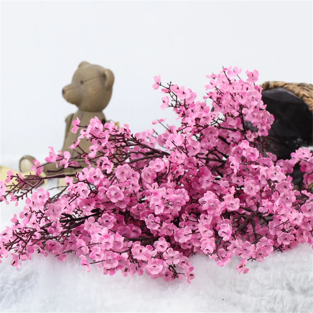 Two artificial Gypsophila flowers in purple, realistic fake floral arrangement by Corporación Turística for home decor.