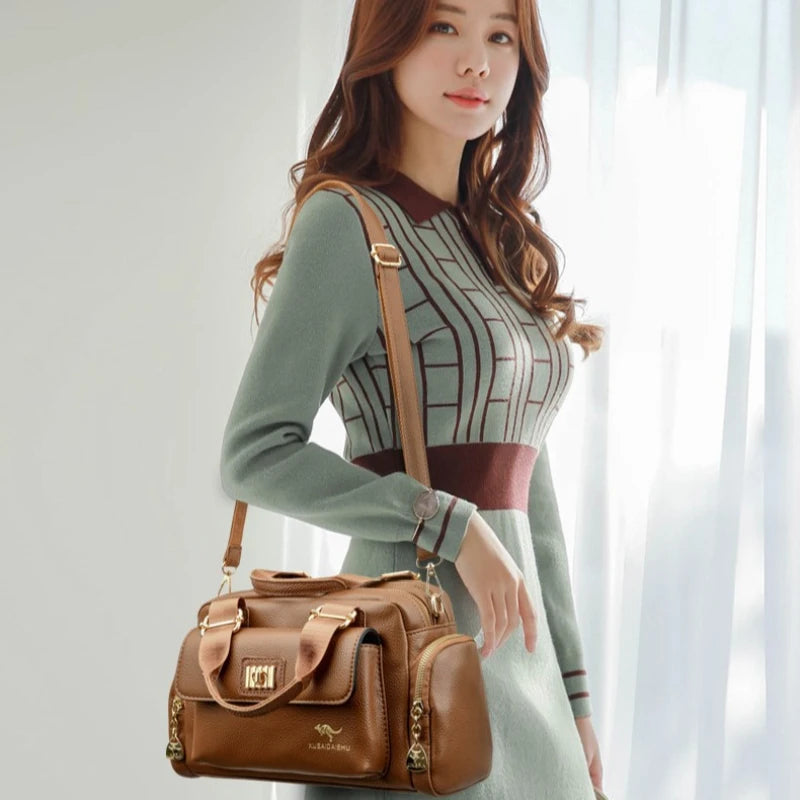 Luxury designer purple shoulder bag and matching clutch by Corporación Turística, stylish and elegant for upscale occasions.