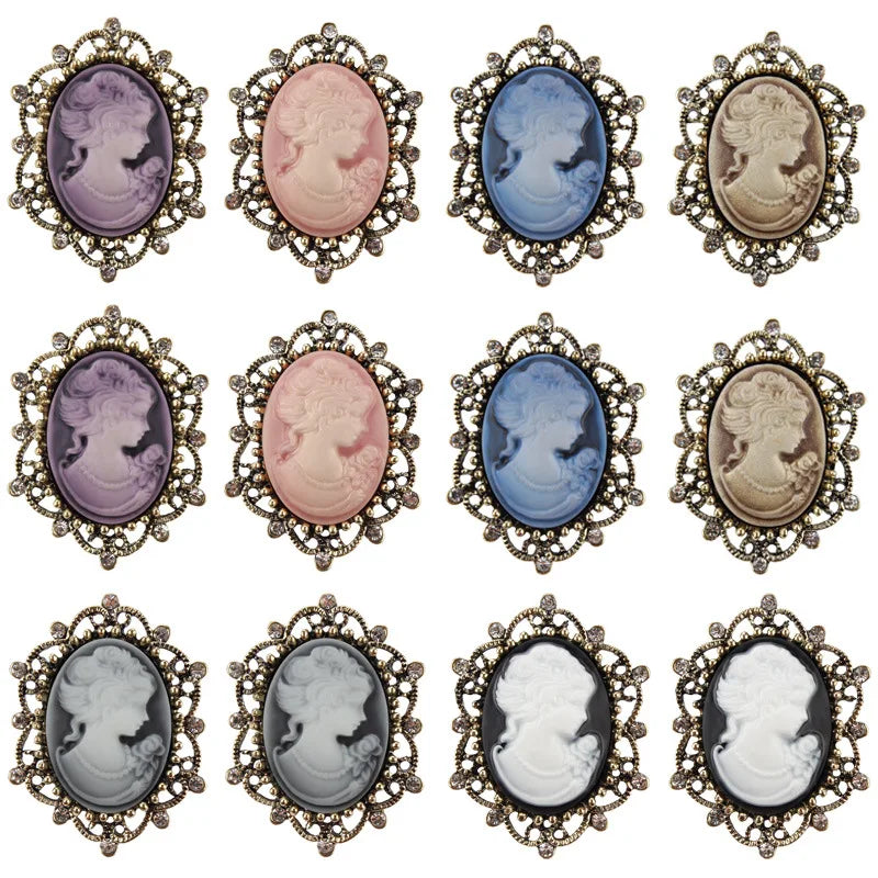 Vint-style Queen cameo brooch with imitation diamonds, featuring purple and gold accents, worn as a decorative jewelry accessory.