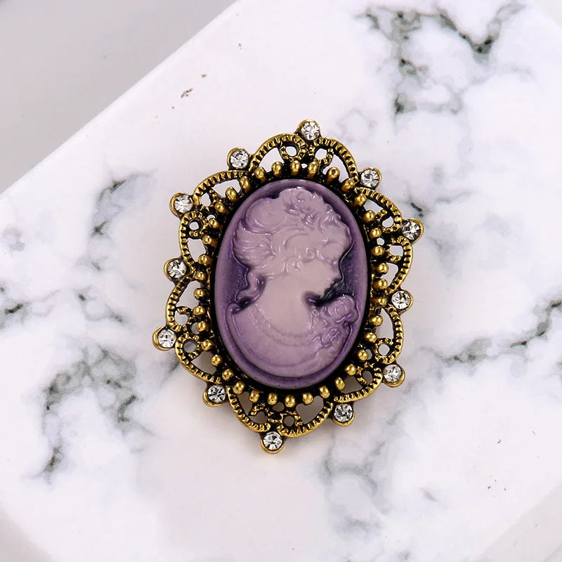 Purple vintage Queen cameo brooch with imitation diamond accents, featuring intricate design and classic jewelry style.