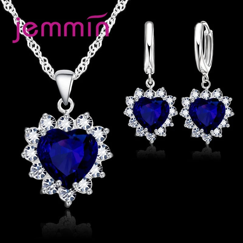Purple jewelry gift sets for anniversaries by Corporación Turística, featuring elegant necklaces and earrings.