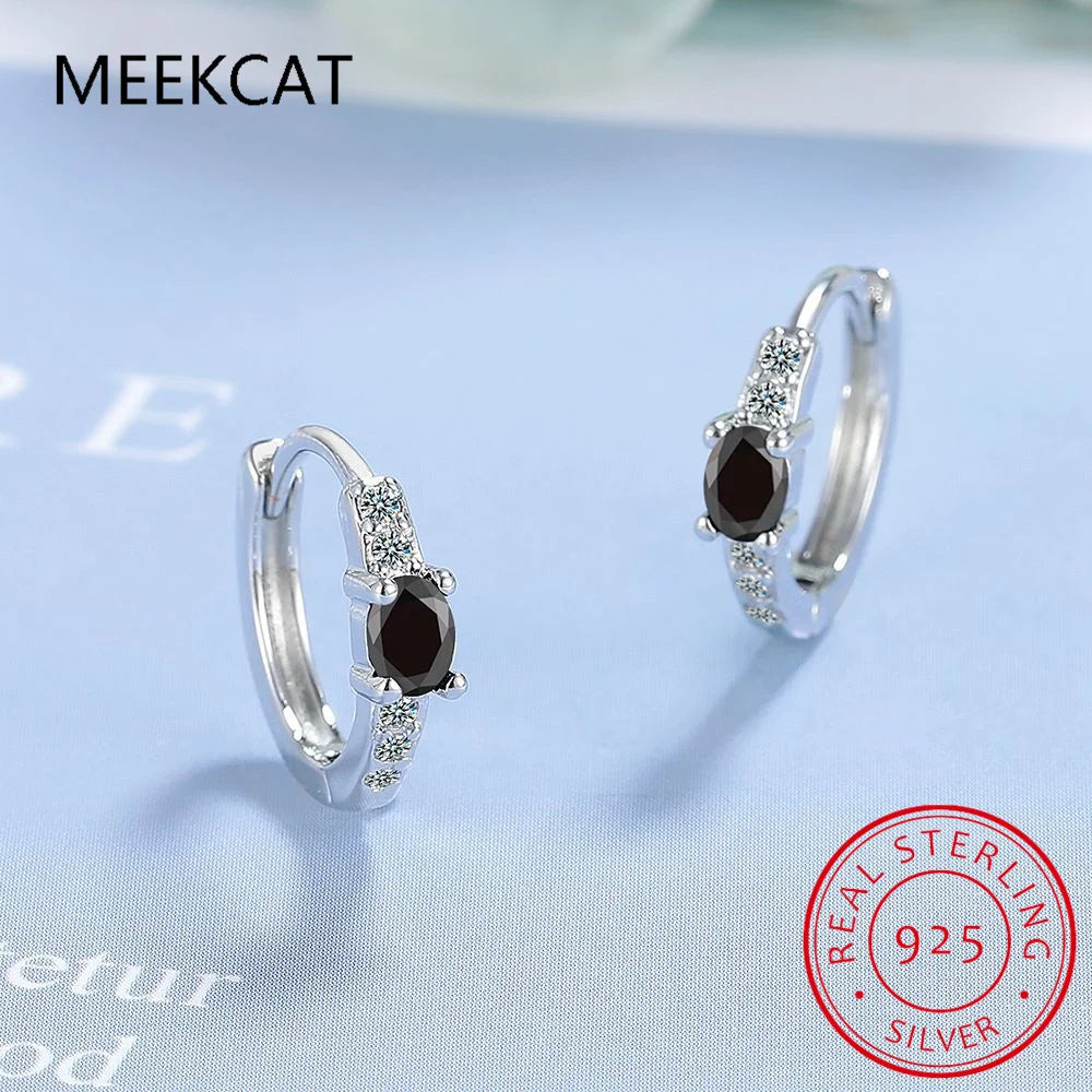 Sterling silver hoop earrings with blue sapphire stones, featuring elegant design and vibrant color.