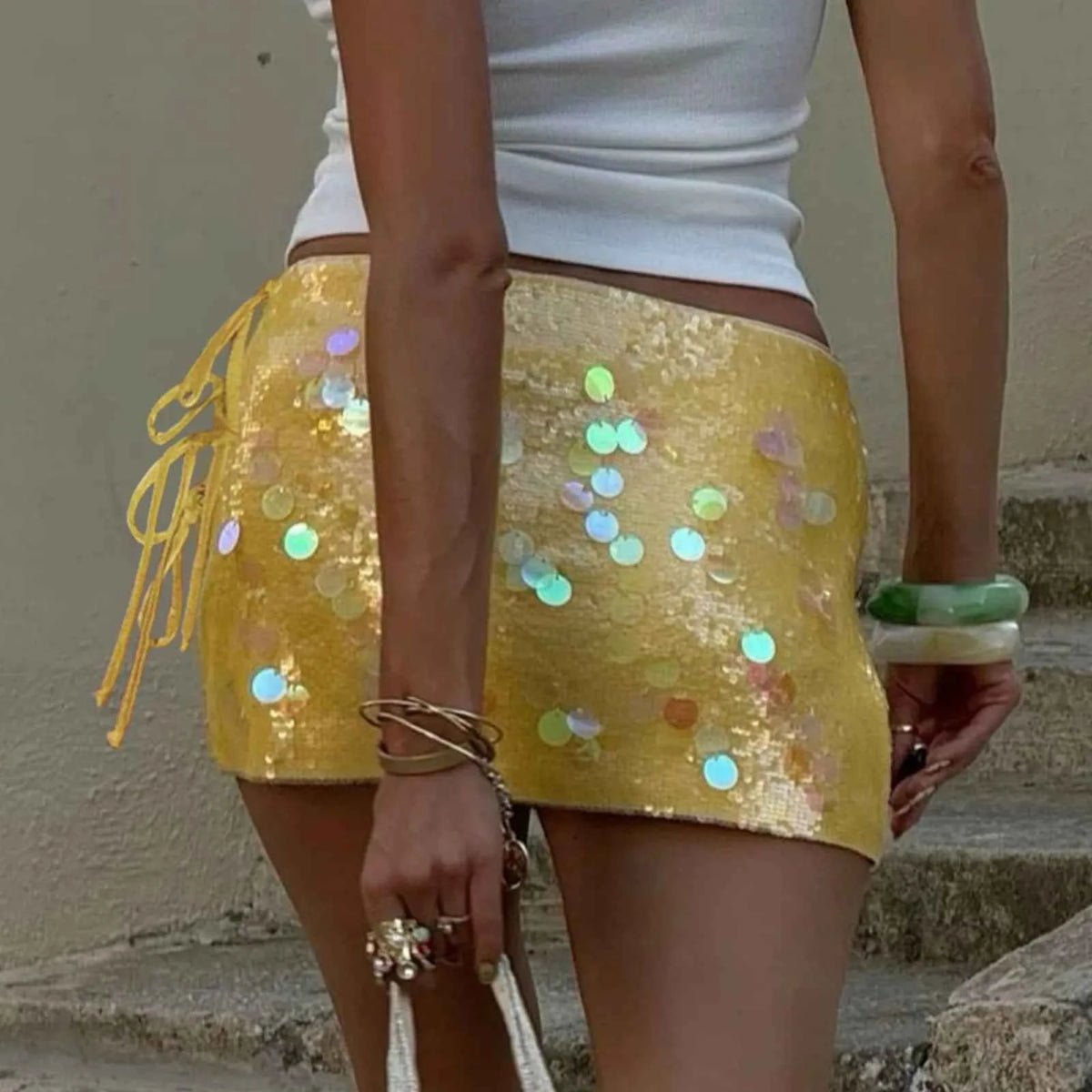 Purple sequin mini skirt for women, short and stylish, from Corporación Turística, shown in a close-up shot.