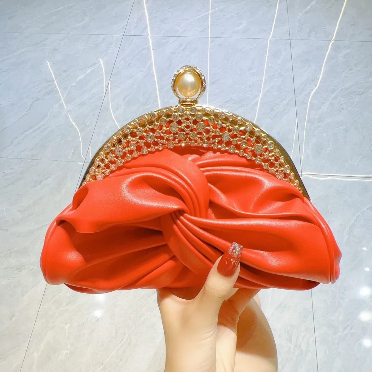 Luxury red women's shoulder bag with chain strap, from Corporación Turística, stylish and elegant accessory for any occasion.