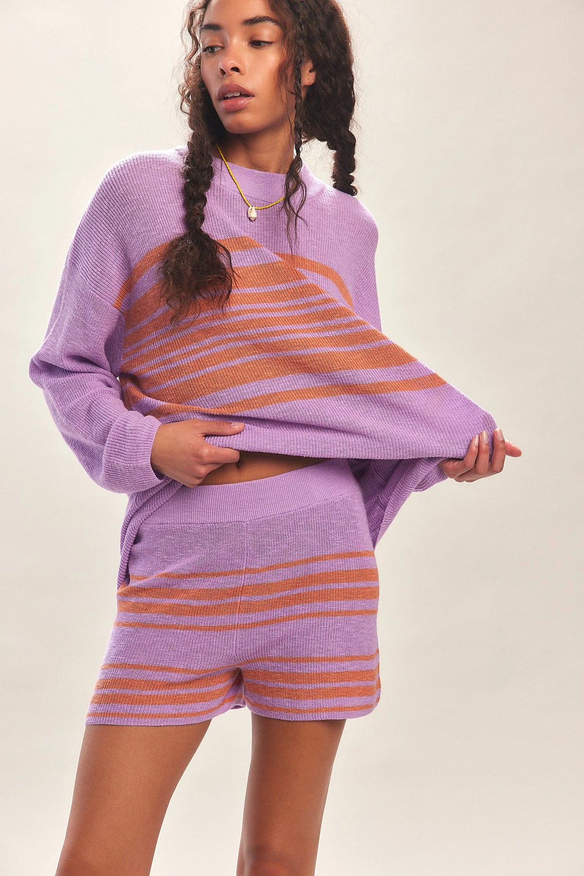 Red women's 2-piece clothing set by Corporación Turística with a sweater and matching pants, shown laid flat.