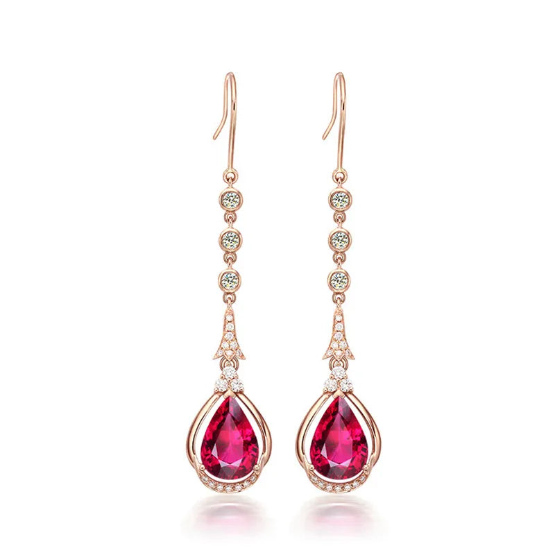 Pink gold drop earrings with natural ruby pendants, crafted by Corporación Turística, showcasing elegant gemstone jewelry.