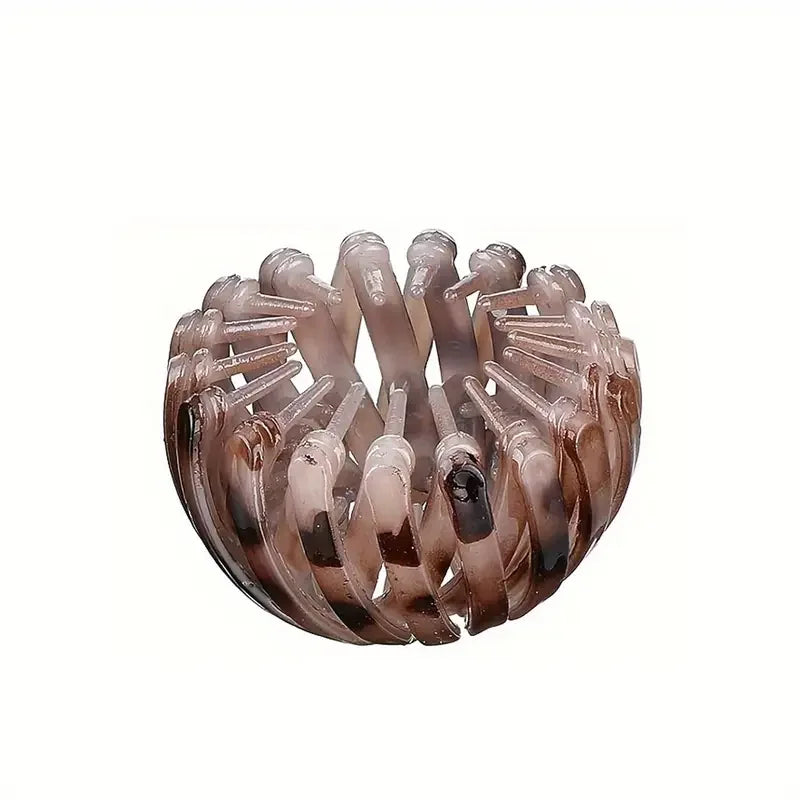 Fashionable bird's nest shaped hair clip from Corporación Turística in red, designed to hold and style hair easily.
