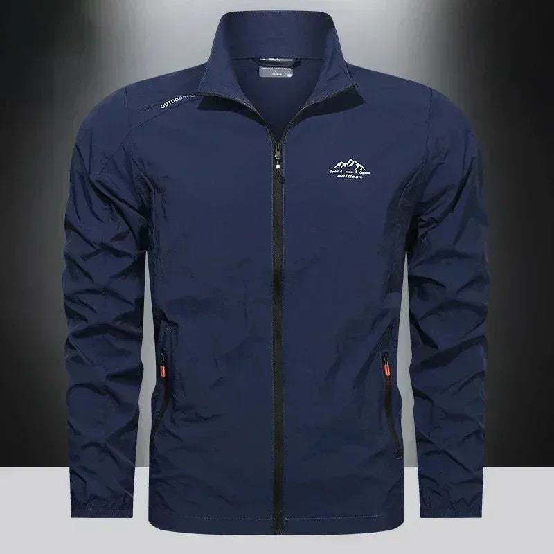 Blue men's UPF100+ summer windbreaker jacket with pockets, lightweight UV protection, denim style, from Corporación Turística.