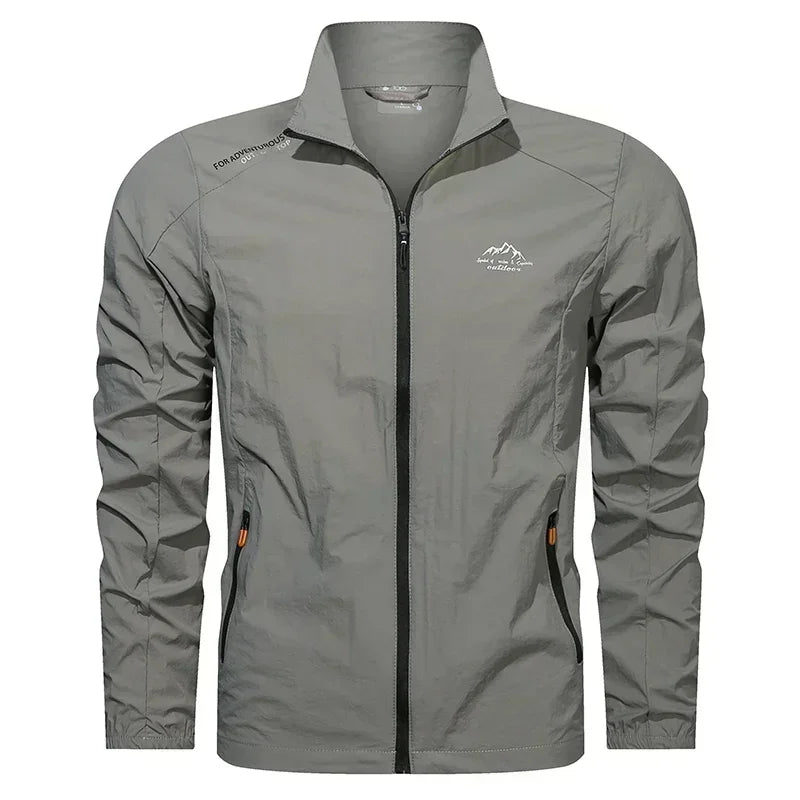 Men's ultralight denim blue UPF100+ summer windbreaker jacket with pockets, perfect for outdoor UV protection by Corporación Turística.