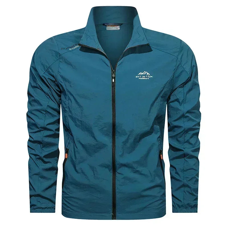 Blue men's UPF100+ summer windbreaker jacket by Corporación Turística with pockets, ultralight outdoor UV protection.