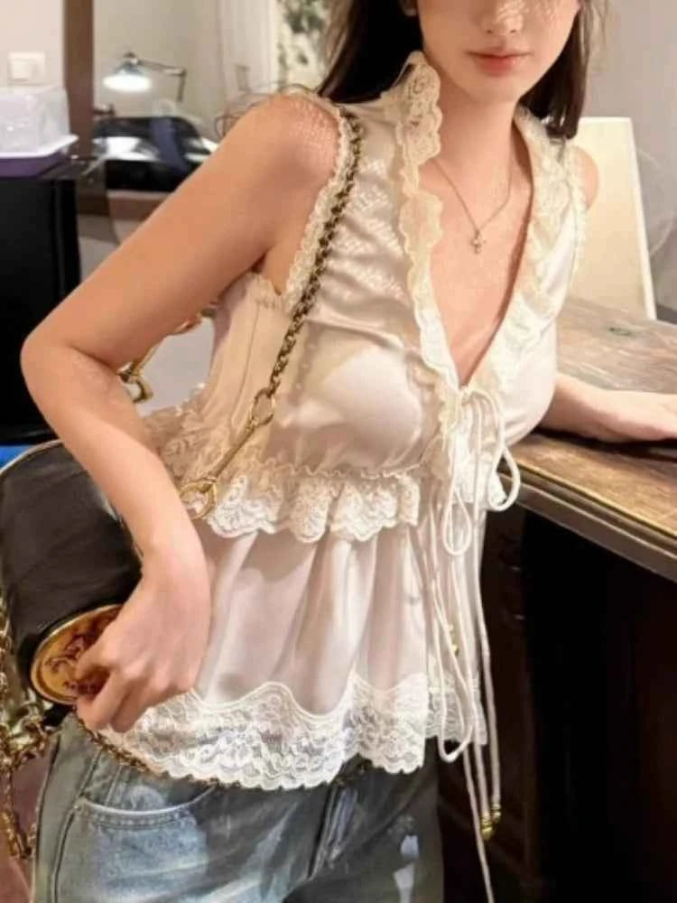 White satin camisola by Corporación Turística with ruffled details and tie-front, perfect for elegant, sensual loungewear.