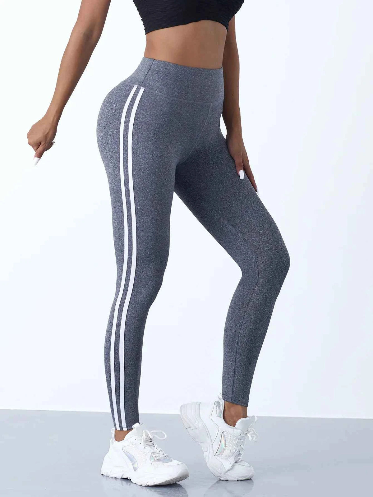 Black and dark grey striped yoga leggings for women with tummy control, ideal for gym and activewear by Corporación Turística.