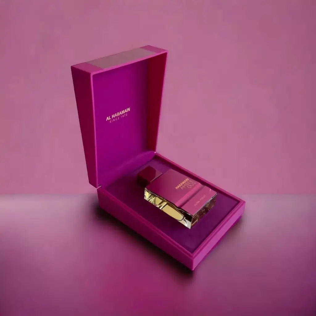 Al Haramain Amber Oud Ultra Violeta perfume bottle, Arab fragrance with floral and woody notes, 60ml, in a pink and gold packaging.