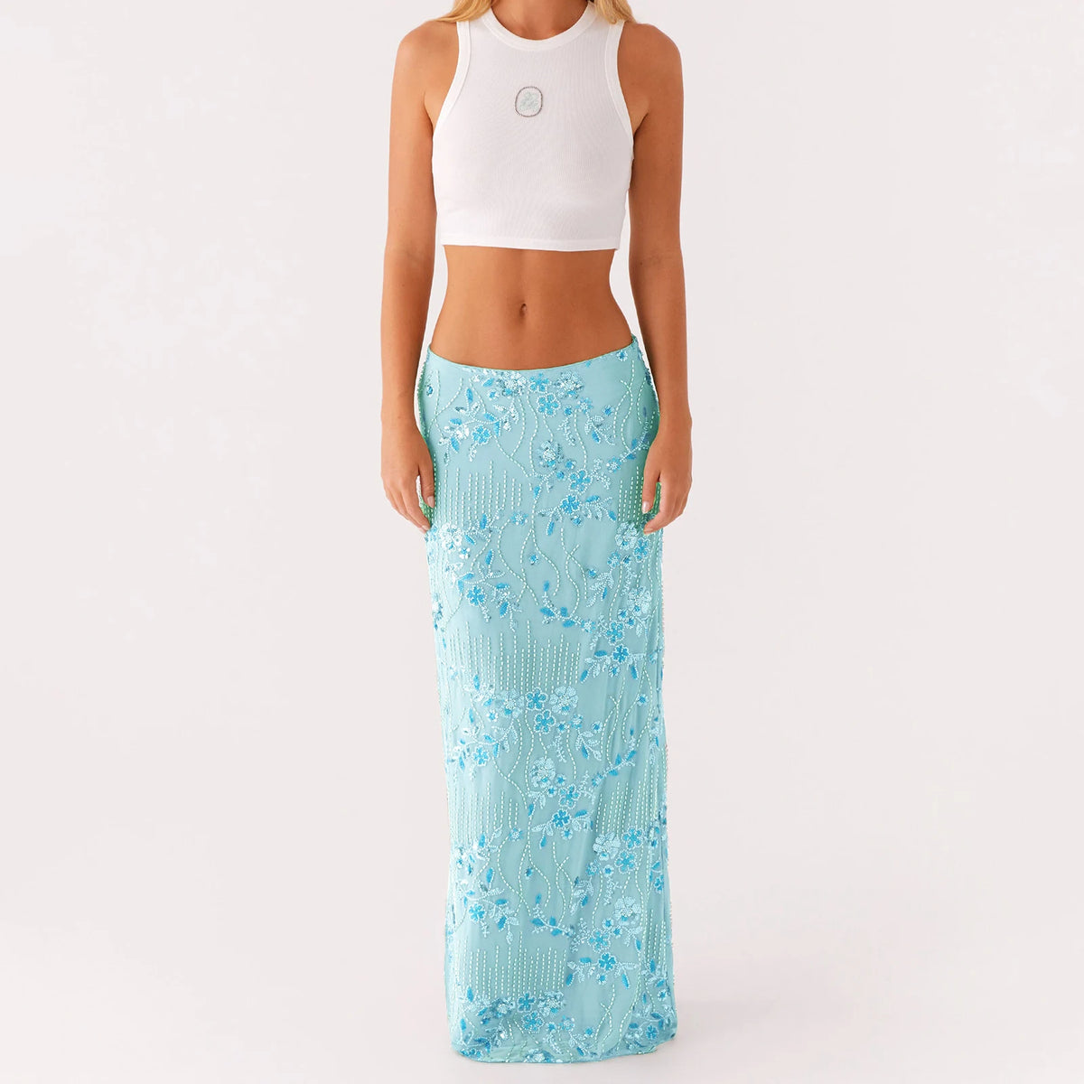 Elegant long skirt for women with sequins and beads, featuring a vibrant pink color and flowing design, from Corporación Turística.