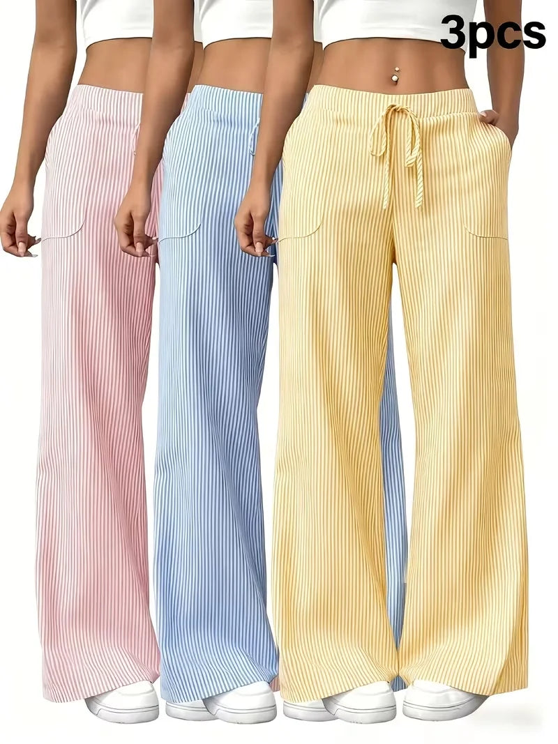 Set of three women's sports pants from Corporación Turística in pink, including different styles and sizes displayed on a flat surface.