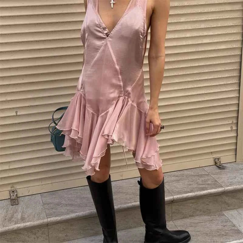 Pink sleeveless V-neck dress for women by Corporación Turística, shown on a mannequin with a flowing fit and elegant design.