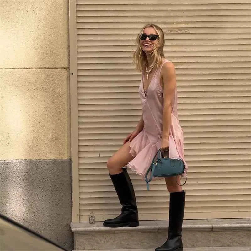 Pink sleeveless women's dress with deep V-neck and fitted style, featuring a stylish cut for elegant occasions.