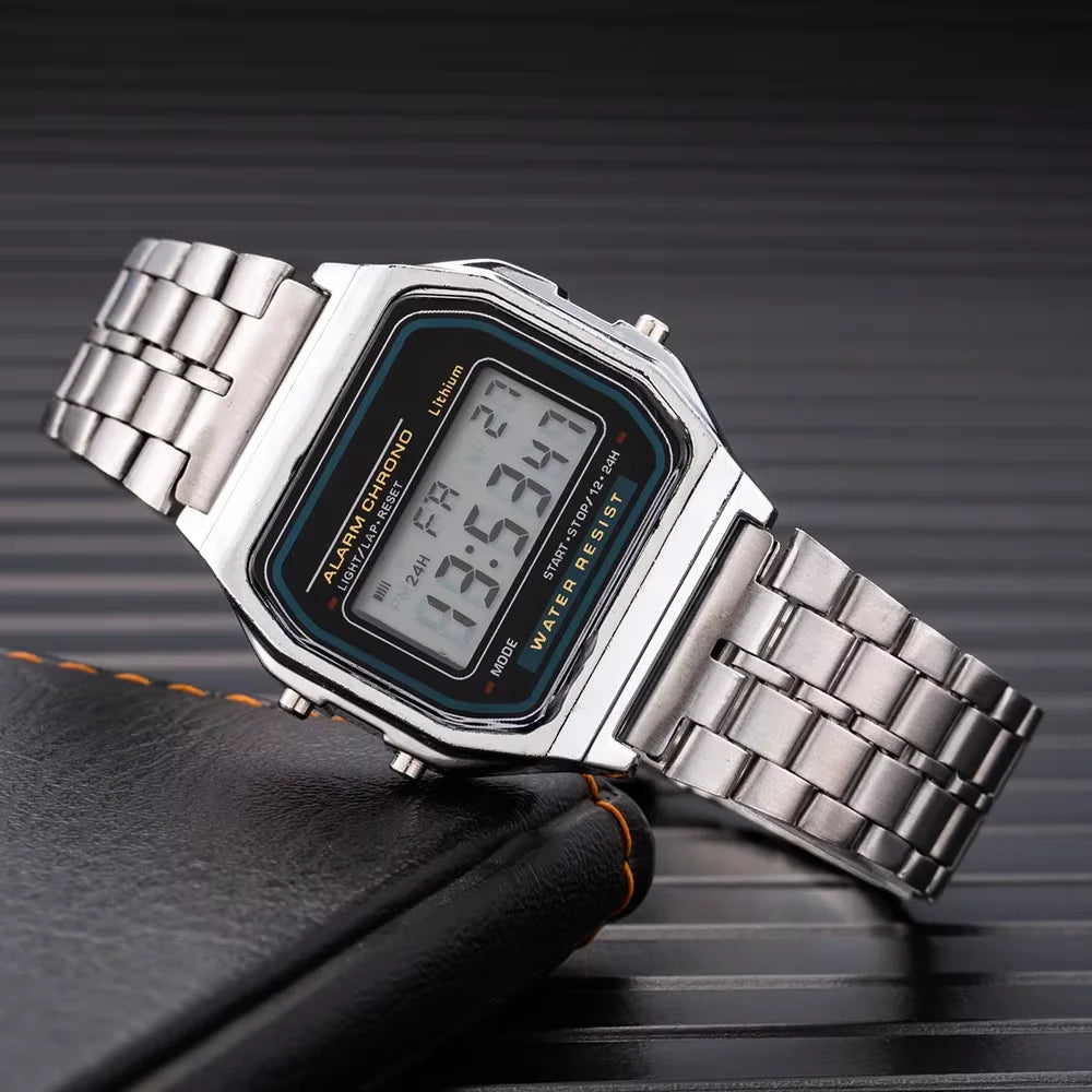 Small square LED electronic watch with stainless steel strap by Corporación Turística, featuring a modern digital display.