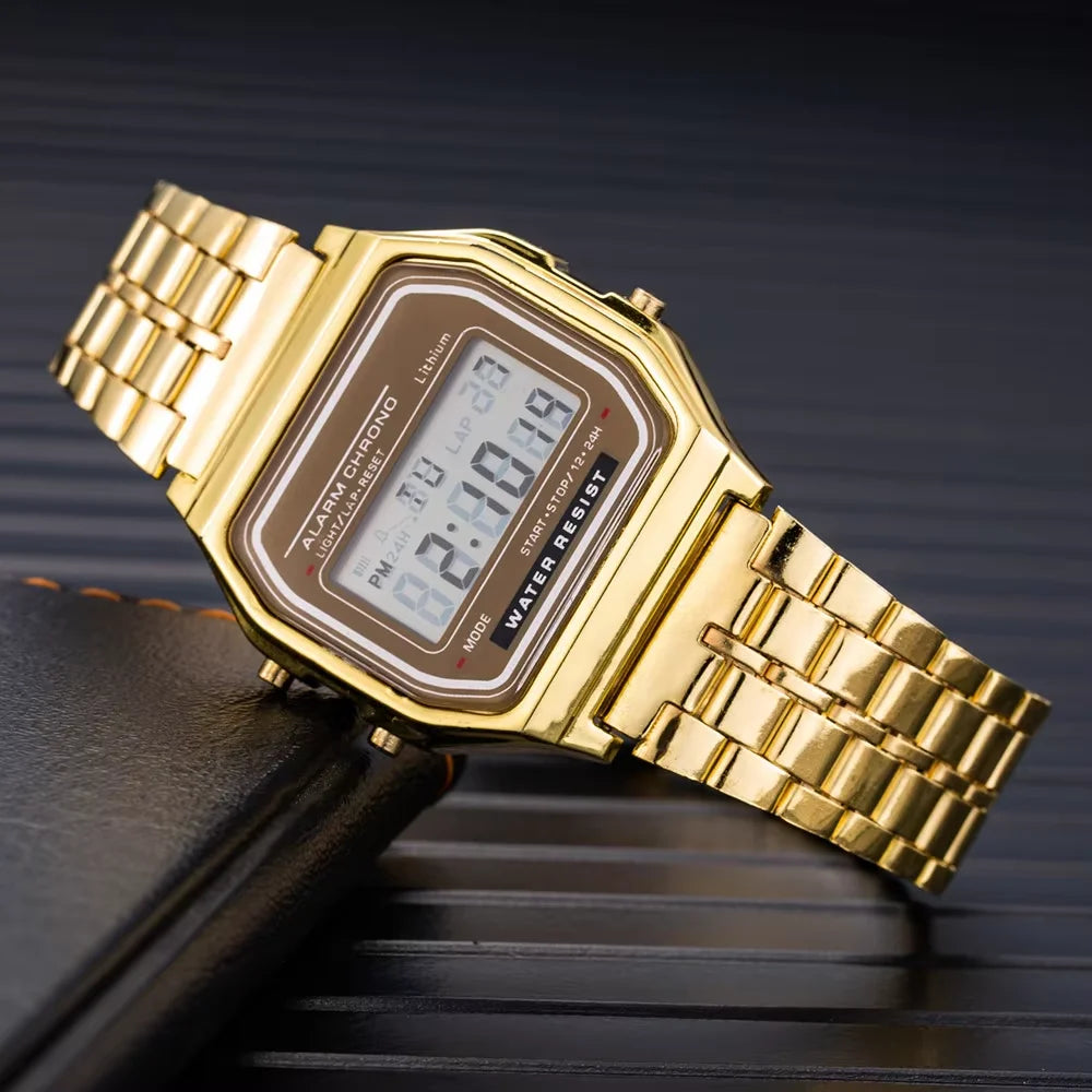 Small square LED electronic watch with stainless steel strap by Corporación Turística, showing digital time display.