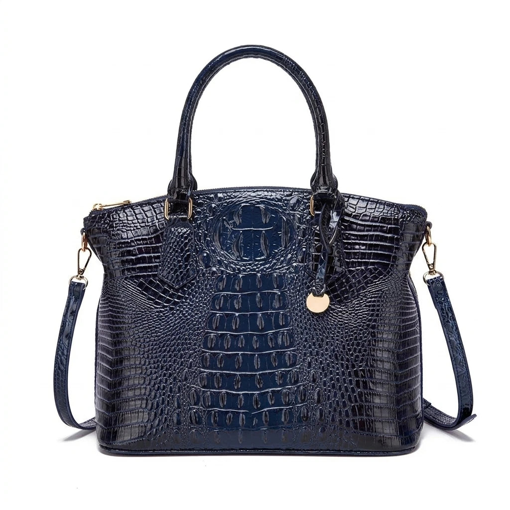 Royal blue and magenta women's tote bag with embossed design, convertible style, by Corporación Turística, shown in a lifestyle setting.