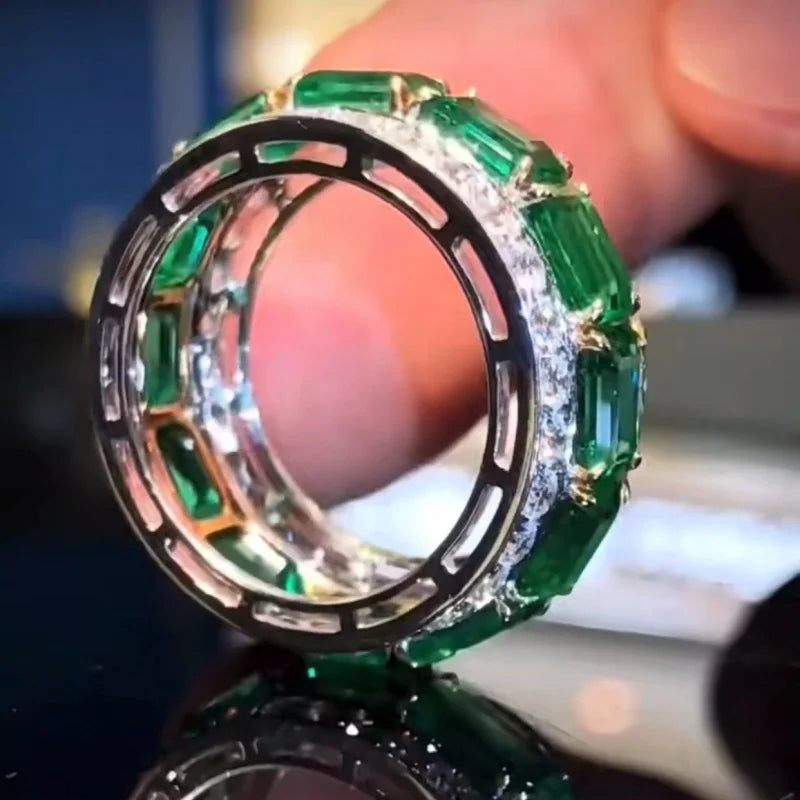 Silver wedding rings with square green stones and full zirconia detailing, crafted by Corporación Turística.