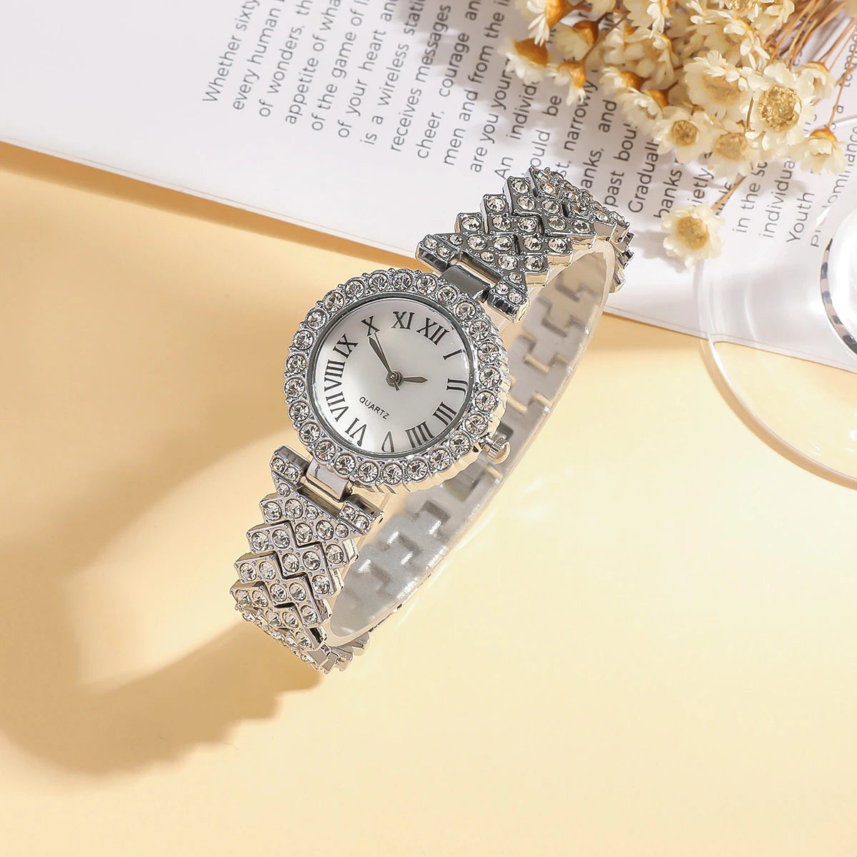 Silver women's watch with Roman numeral dial, featuring a sleek design and classic style, by Corporación Turística.