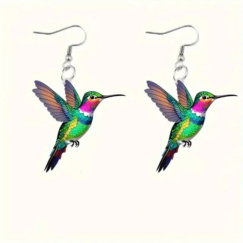 Acrylic hummingbird earrings featuring colorful, detailed bird-shaped designs, stylish jewelry accessory by Corporación Turística.