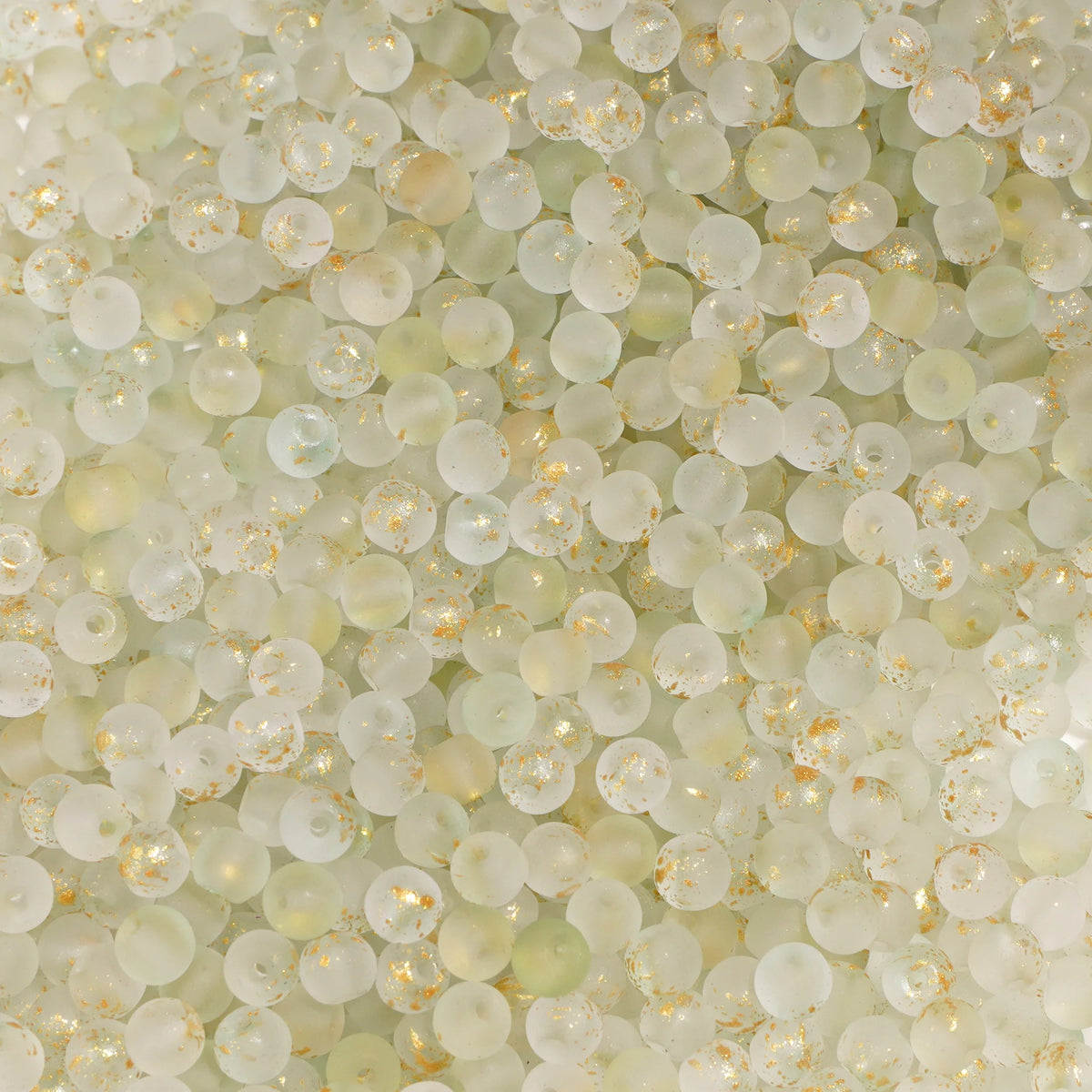 Set of 100 glass rice beads with gold splashes, decorative jewelry-making beads, from Corporación Turística.