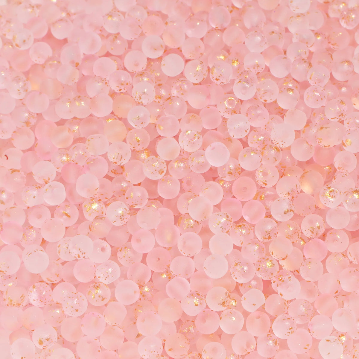 Set of 100 gold-splashed glass rice beads by Corporación Turística, 4mm size, small round jewelry-making beads.
