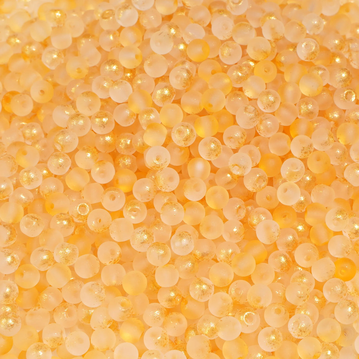 Set of 100 gold-splashed glass rice beads from Corporación Turística, 4mm size, perfect for jewelry making and craft projects.