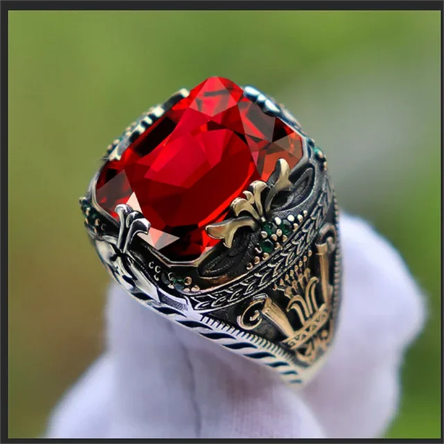 Luxury emerald ring with intricate gemstone inlays, designed for the shoulder, by Corporación Turística.