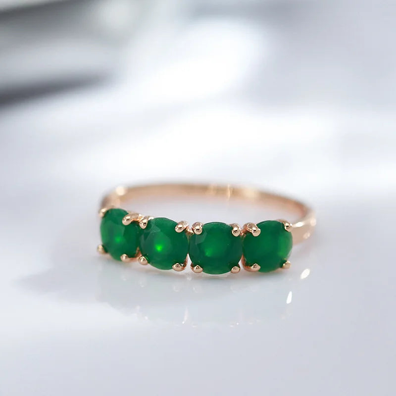18K rose gold women's ring with a green emerald gemstone, featuring a elegant design and crafted by Corporación Turística.