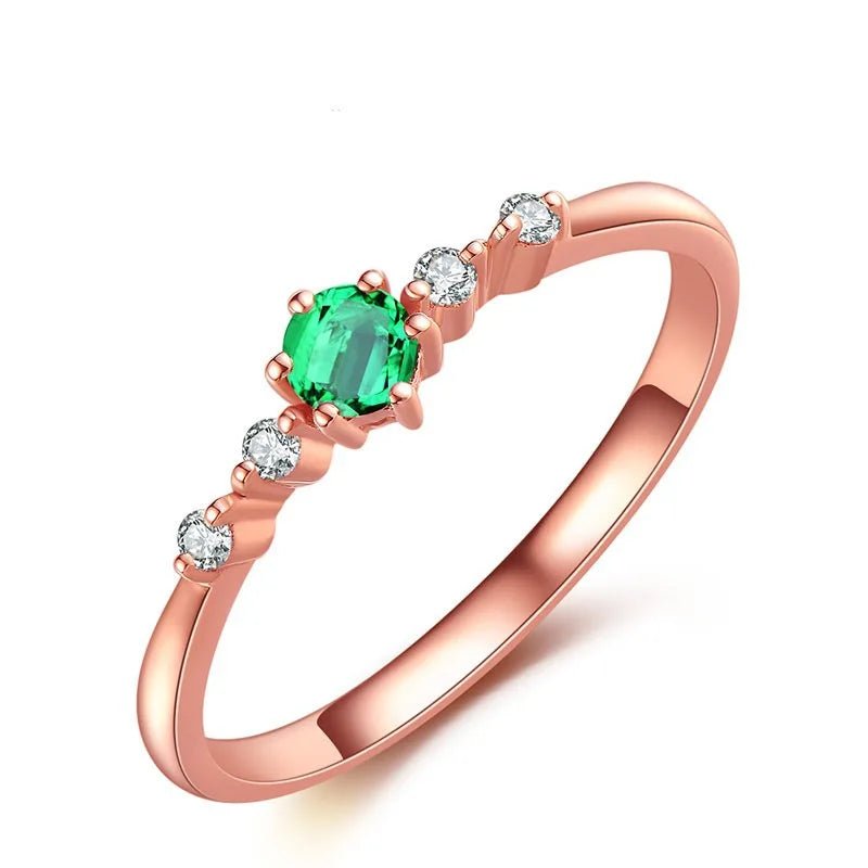 Rose gold and natural emerald ring for women, featuring a band design with vibrant green emeralds and elegant craftsmanship.