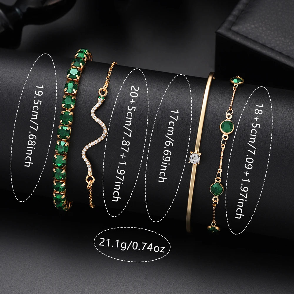 Luxurious 6-in-1 jewelry set by Corporación Turística featuring a watch, necklace, earrings, and ring on a green background.