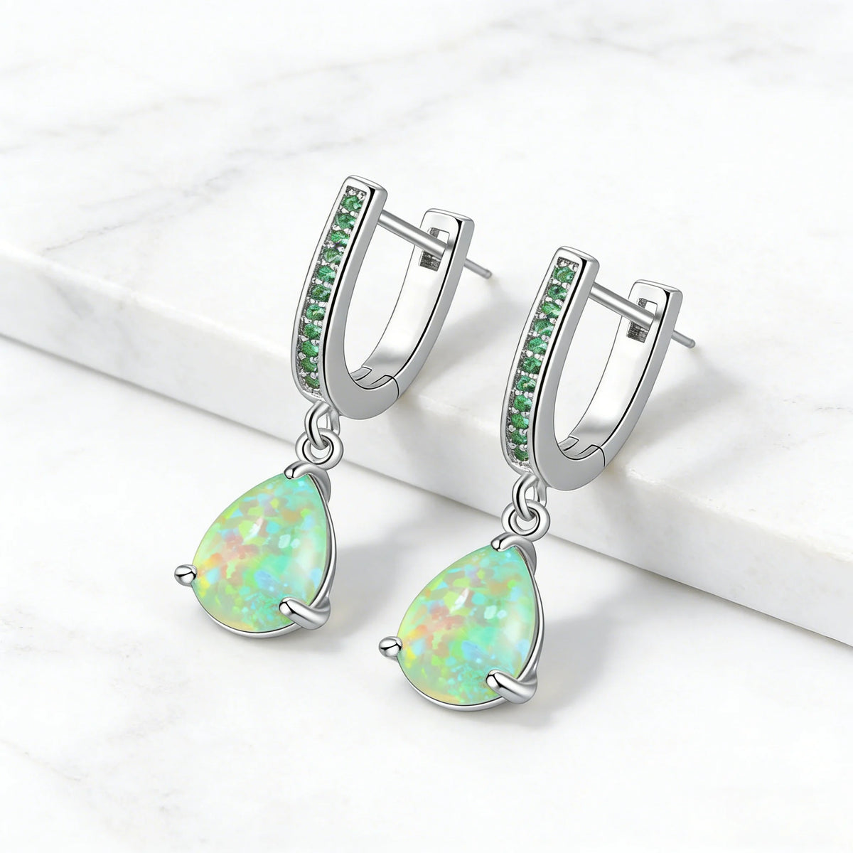 Green fire opal dangling earrings for women, featuring vibrant gemstone pendants with silver hooks.