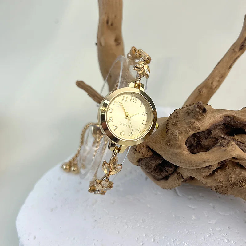 Elegant women's quartz watch with a round gold-tone case by Corporación Turística, featuring a stylish green strap.