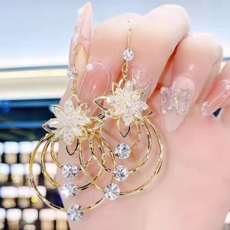 Exquisite floral and circle design earrings by Corporación Turística, elegant gold-tone jewelry for stylish looks.