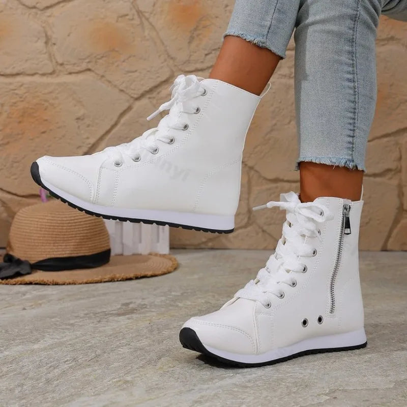 White women's spring and fall ankle boots from Corporación Turística, featuring a stylish, comfortable design and flat sole.