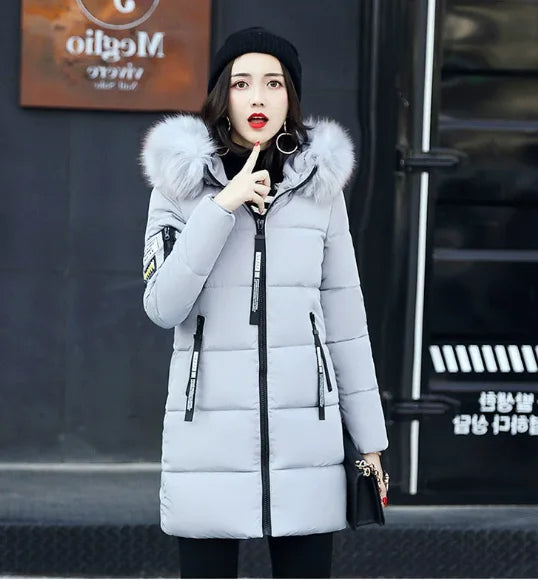 White women's winter parka coat with faux fur collar by Corporación Turística, ideal for cold weather and stylish winter wear.